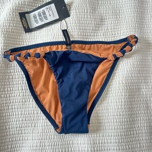This is a Vix Paula Hermanny solid knot bikini bottom in navy blue. New w tags